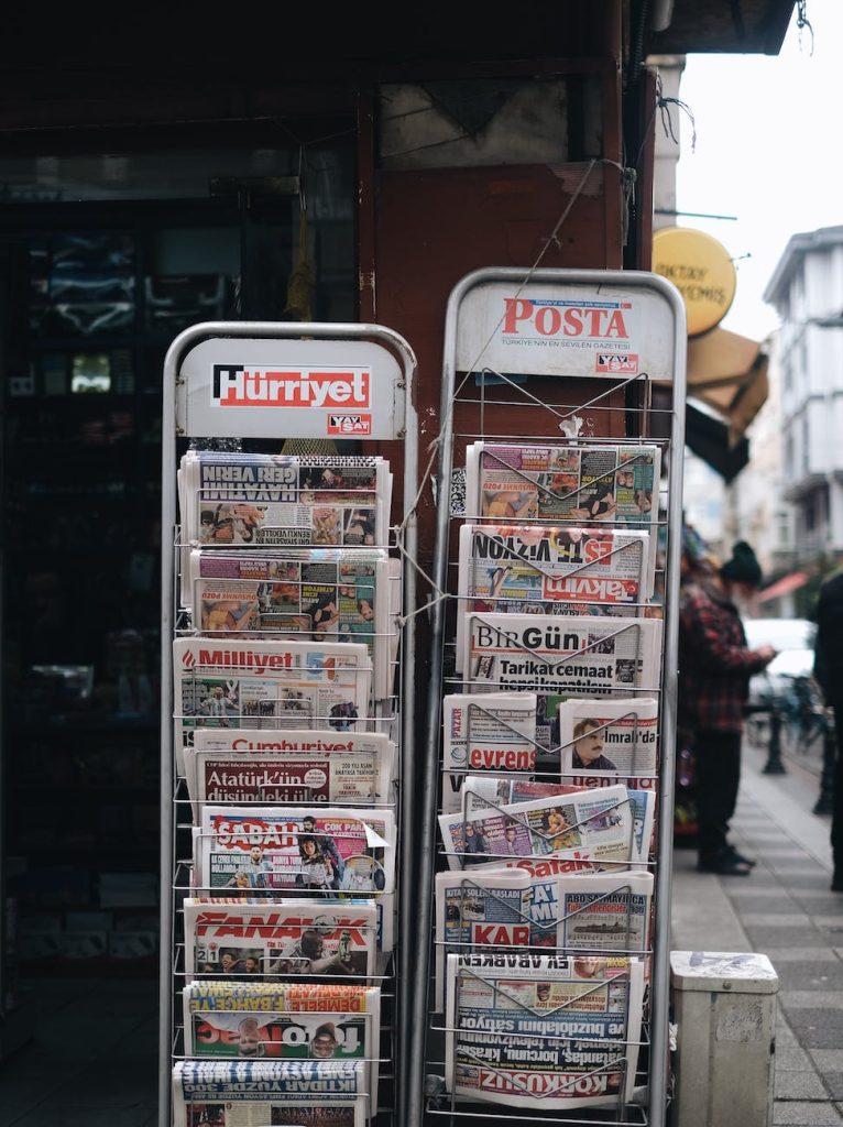 newspapers on metal rack
